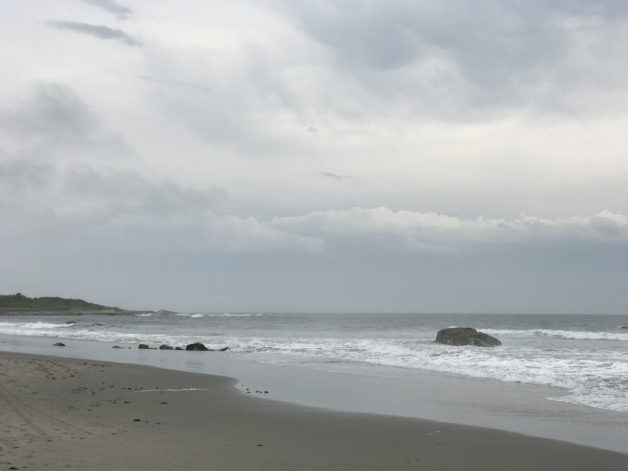 A Rhode Island beach under cloudy skies.