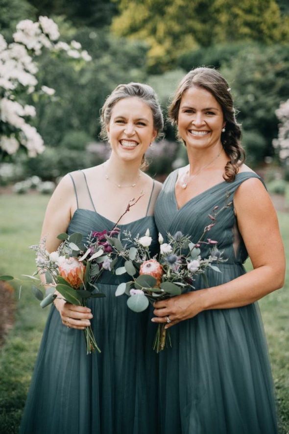 Kristen and her sister in bridesmaid dresses.