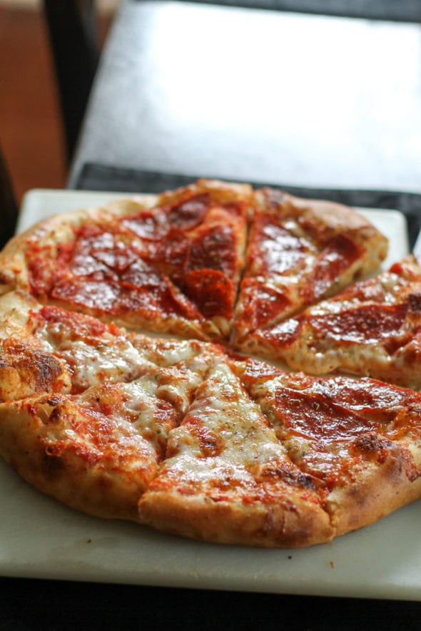 A sliced, homemade cheese pizza.