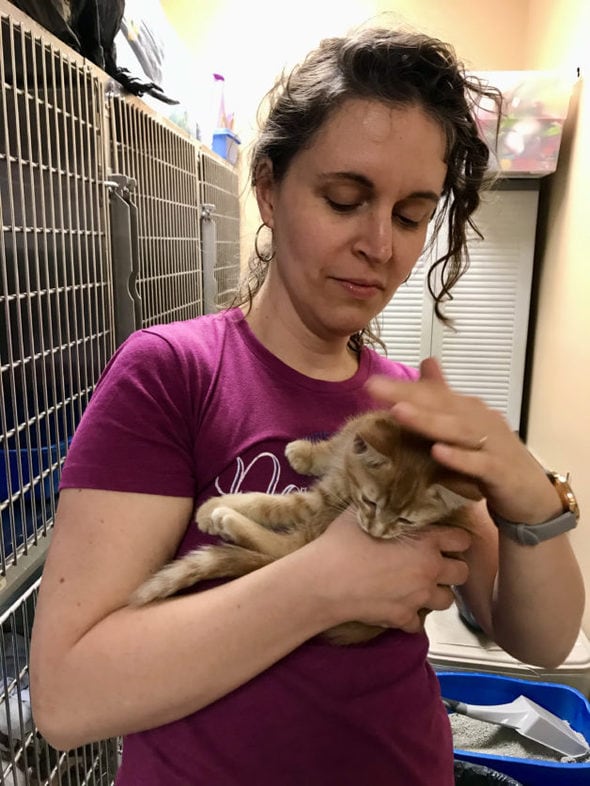 Kristen holding a light brown kitten.