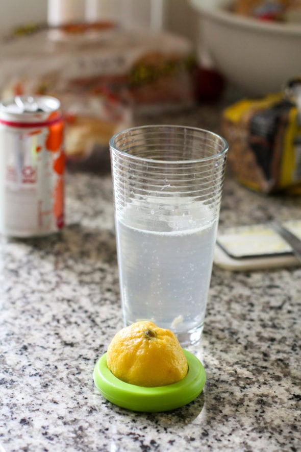 A glass of water with lemon juice in it.