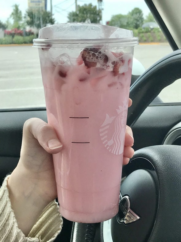 Trenta pink drink, held in someone's hand.