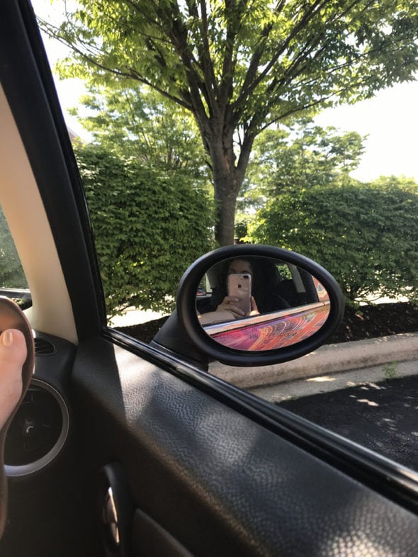 A view outside a car window on a sunny morning.