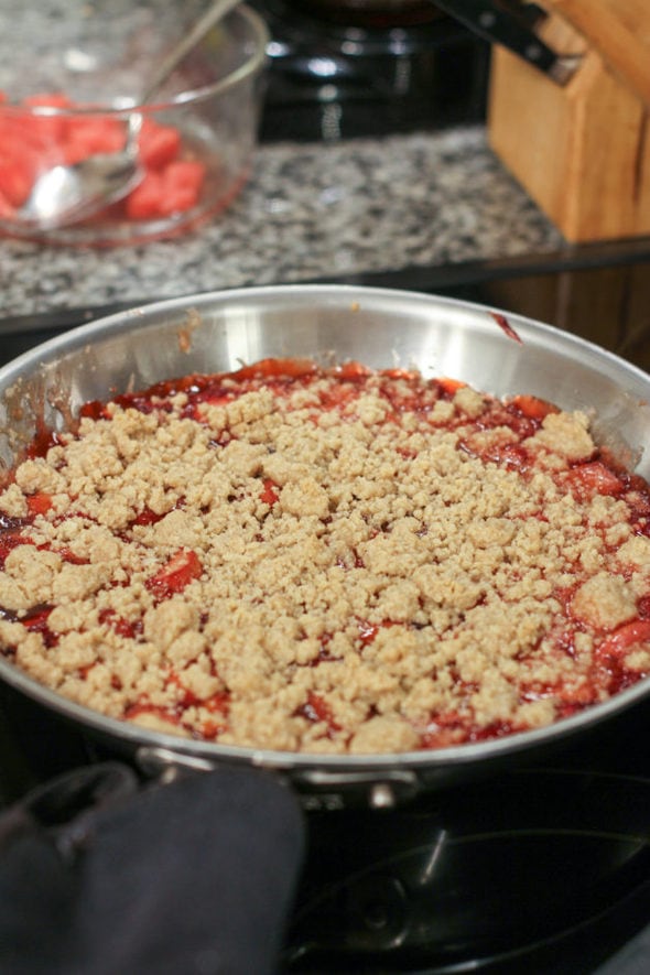 Strawberry rhubarb crisp in a skillet.