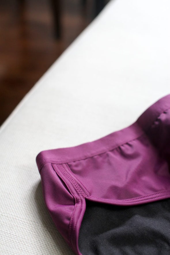 A side waistband of a pair of purple Thinx underwear.