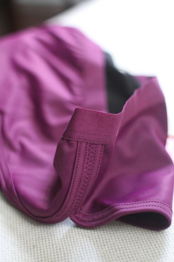 The elastic waistband of a purple pair of Thinx underwear.