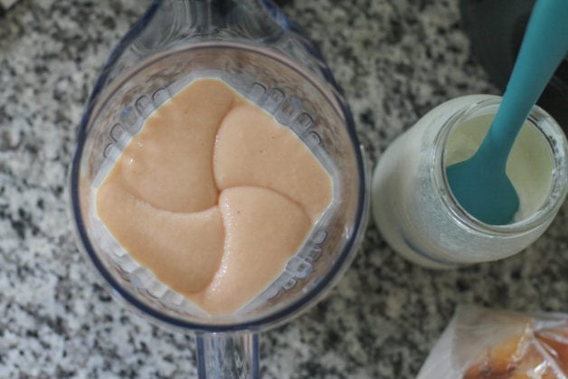 A peach smoothie in a vitamix, viewed from above.