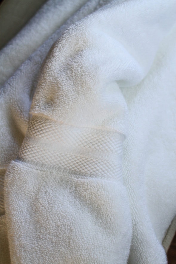 A fluffy white cotton bath towel.
