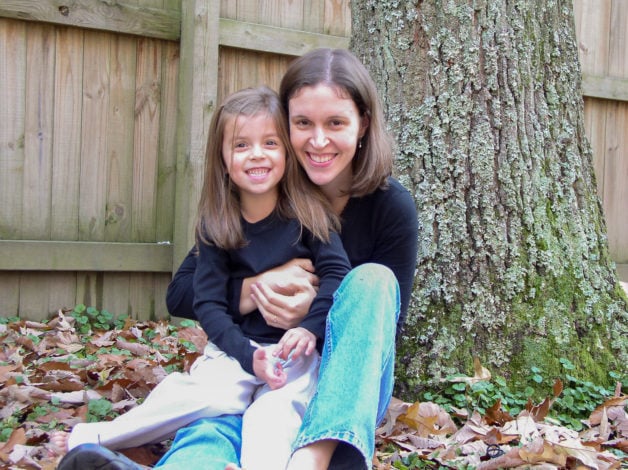 Kristen and 5 year old Lisey, sitting in front of a tree.