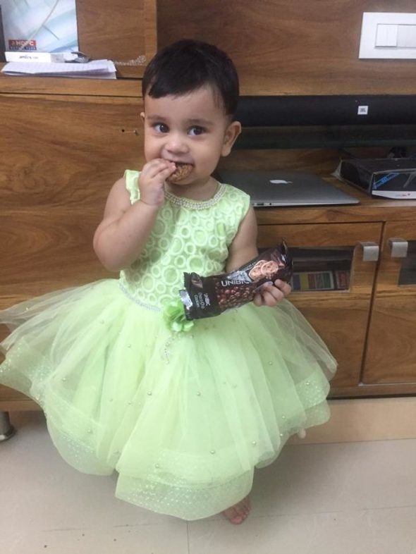 Sonia's daughter in a green dress.