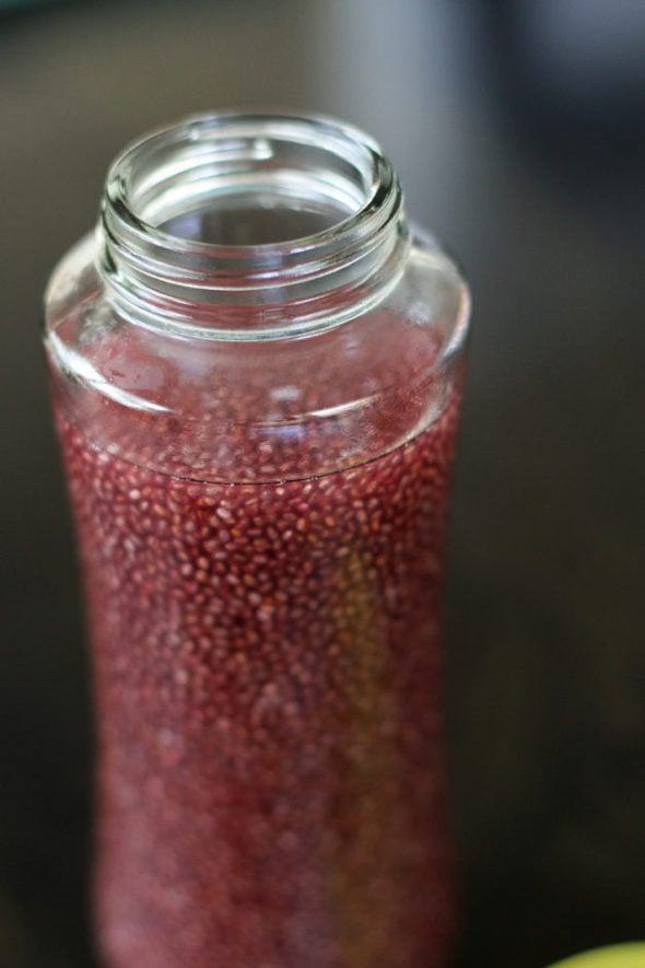 A glass bottle filled with chia juice.