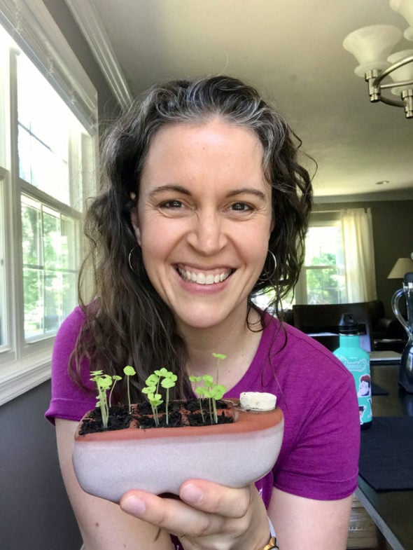 Kristen holding an Orta seed-starter pot.