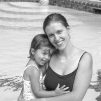 Black and white photo of Kristen and preschool Lisey in a swimming pool.