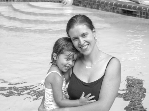 Black and white photo of Kristen and preschool Lisey in a swimming pool.