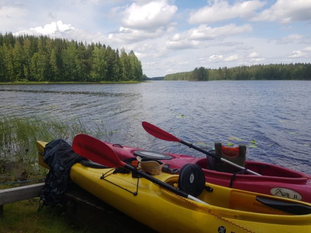 Two kayaks by a lake.