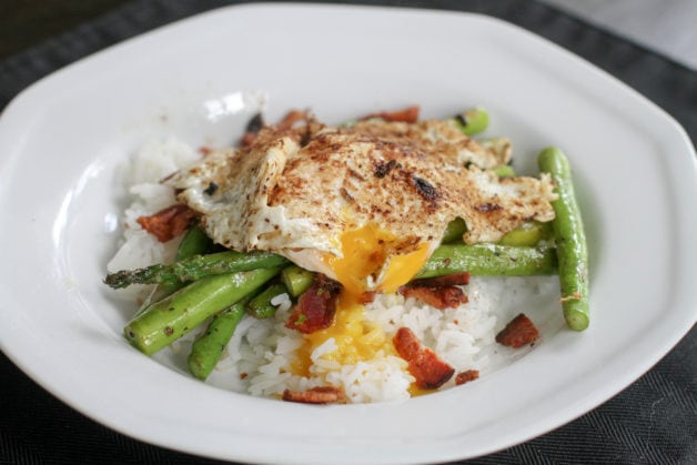 Rice bowl with veggies and a fried egg.