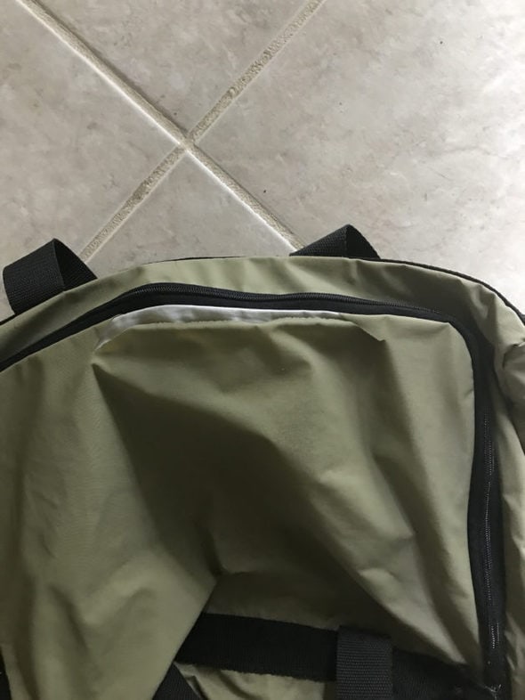 duffel bag with a rip in the top.