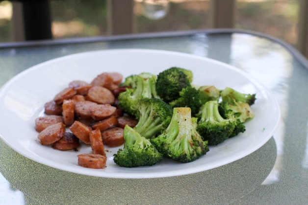 A plate of broccoli and sausage.