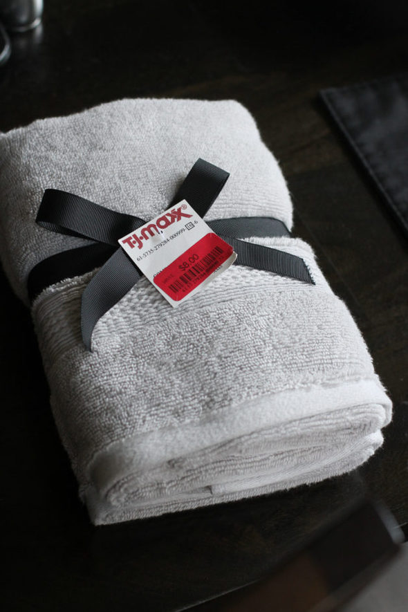 Gray hand towels tied with a black ribbon.