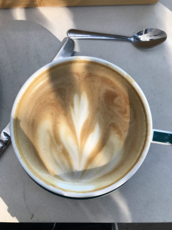 A latte in a mug.