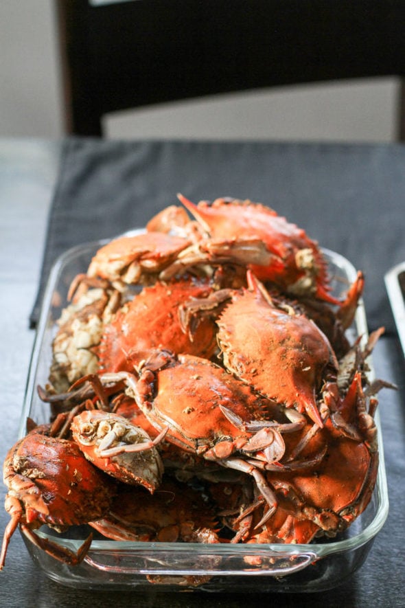 A glass dish of steamed crabs.