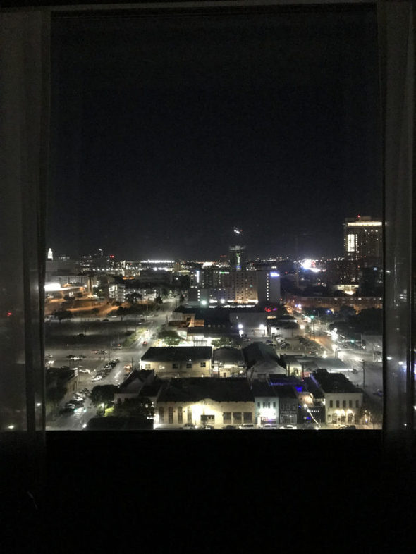 A view of the night sky from a city hotel room.