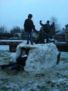Boys on a snow igloo.