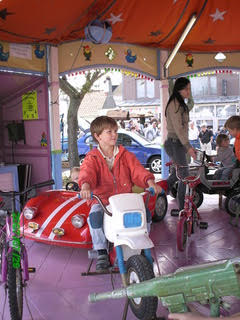 A little boy on an amusement park ride.