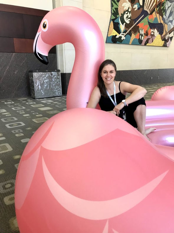 Kristen sitting in a giant inflatable flamingo.