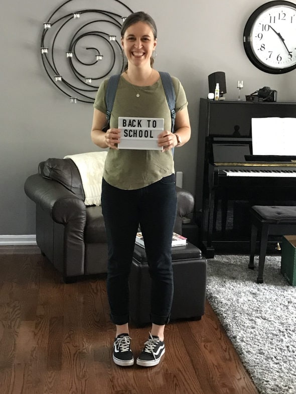 Kristen holding a back to school sign.