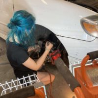 Lisey taking off her car brakes.