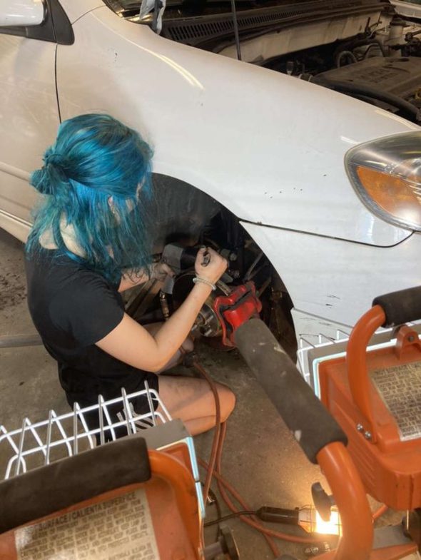 Lisey taking off her car brakes.