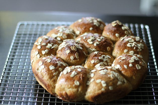 oatmeal rolls cooling on a wire rack.