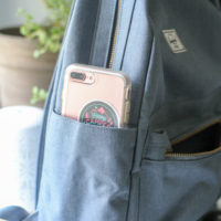 A pink phone in a blue backpack pocket.