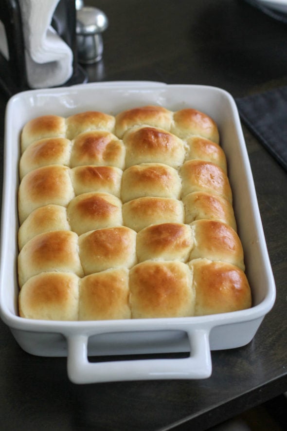 Potato rolls in a white oblong pan.