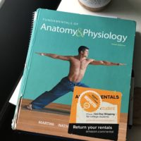 Anatomy and Physiology textbook with a green cover.