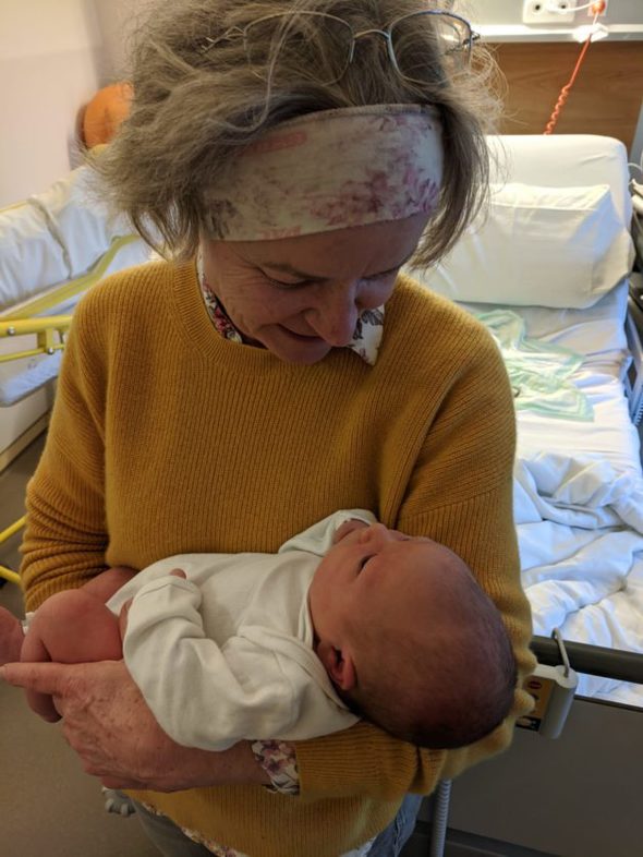Lea holding her grandson.