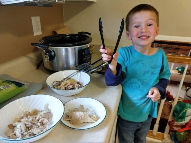 Dorinda's son with a pair of tongs.