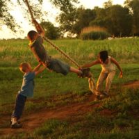 Children on a rope swing.