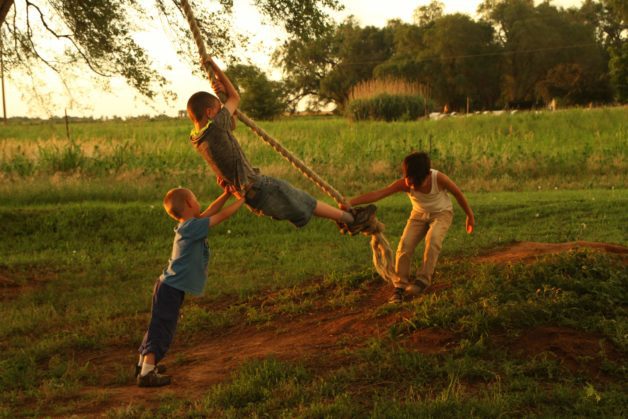 Children on a rope swing.