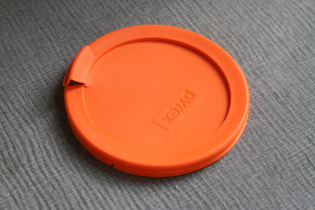 A cracked orange pyrex lid.