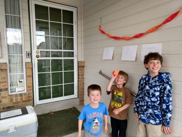 Three boys on a porch.