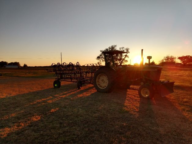 A tractor in the sunset.