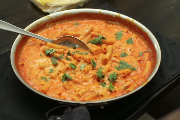 Skillet ziti topped with basil.