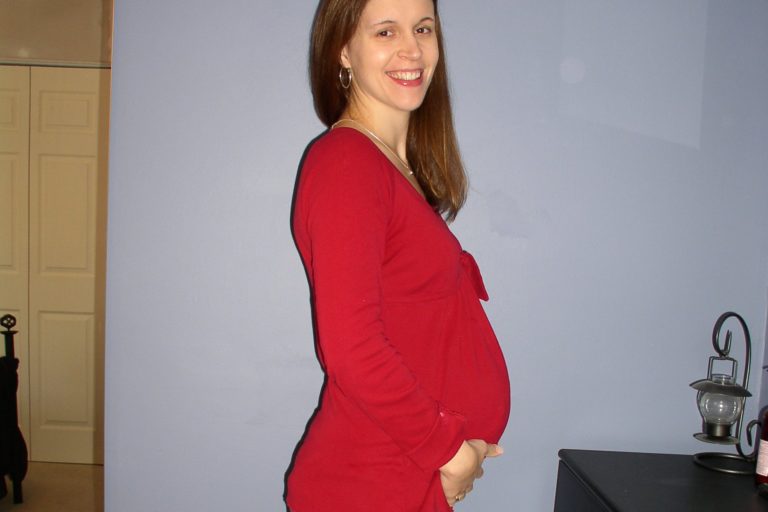 Kristen, pregnant, wearing a red shirt.