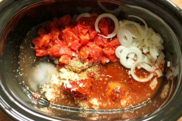 Tinga ingredients in a black crock-pot.