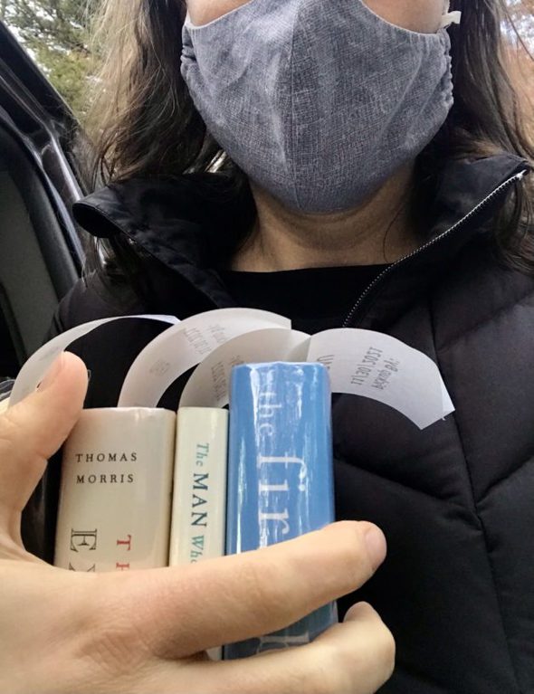 Kristen holding three library books.