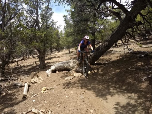 A woman mountain biking.