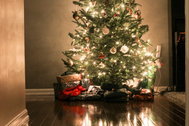 Tree lights reflected in a wood floor.