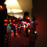 colored christmas lights on a railing.